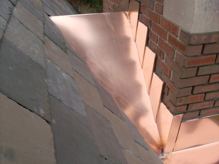 Custom copper chimney saddle, stepped copper counter flashing.