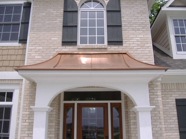 Custom copper standing seam awning over front door.