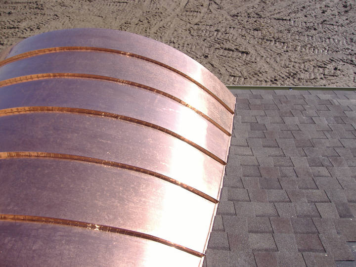Copper barrel dormer standing seam roof - low slope roof.