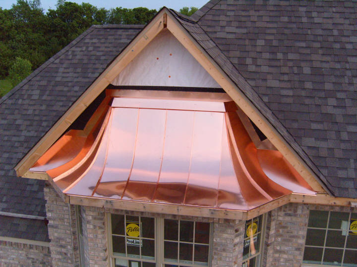 Copper standing seam bay window roof, finished later with vinyl siding.