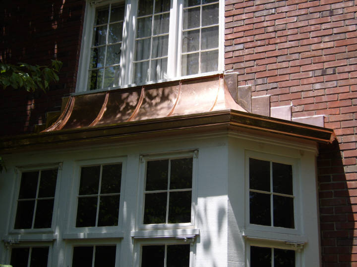 Custom copper hood with stepped copper counter flashing, and 6" K style copper gutter.