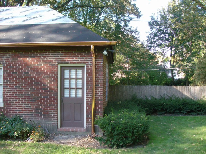 Custom copper half-round gutter with 4" round downspout.